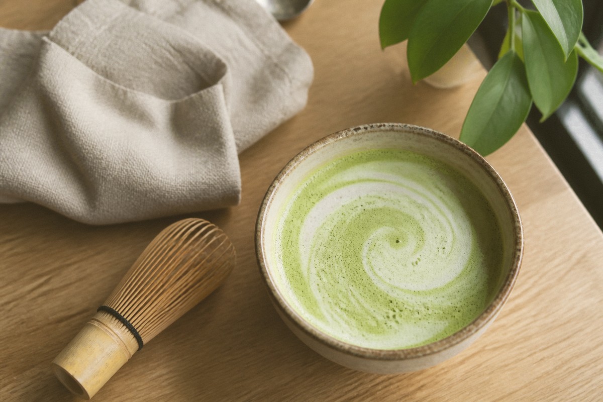 Matcha latte photo with Hojicha filter—warmer roasted olive tones and brown-green shadows