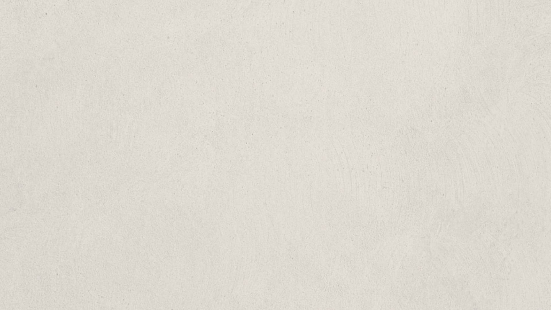 Example of a soft textured plain color background with paper grain and warm gradient tones